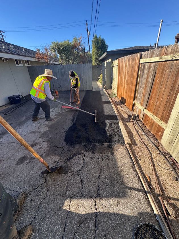 Ochoa Grading & Paving crew placing new asphalt in Costa Mesa