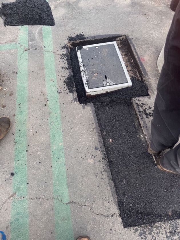New asphalt placed around an electrical box in a saw-cut trench in Irvine, CA